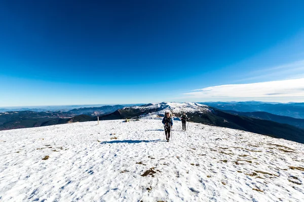 Pareja caminando en la cima de la montaña — Foto de Stock