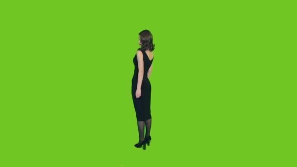 Fille en robe noire sur un fond vert — Video