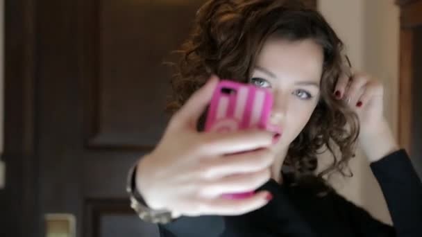 A girl takes pictures of yourself on your phone — Stock Video