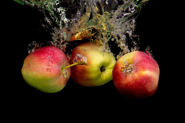 Manzana en el agua sobre fondo negro — Foto de Stock