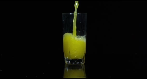 Ett glas juice hälls i slow motion — Stockvideo