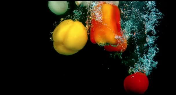 Fruit in water on a black background — Stock Video