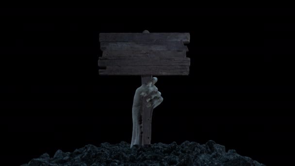 Una mano zombi con un letrero de madera sale del suelo con un canal alfa — Vídeo de stock