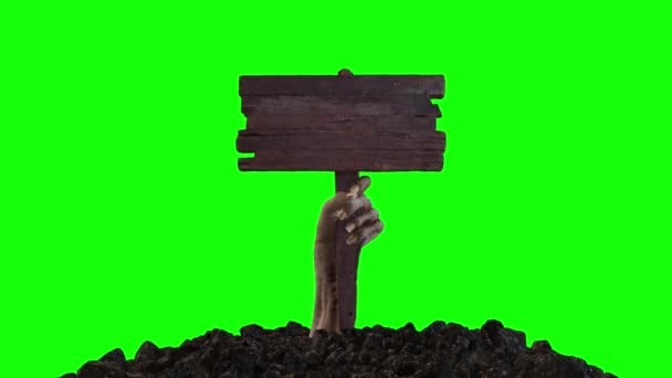 Ένα χέρι ζόμπι με μια ξύλινη πινακίδα σέρνεται έξω από το έδαφος σε μια πράσινη οθόνη — Αρχείο Βίντεο