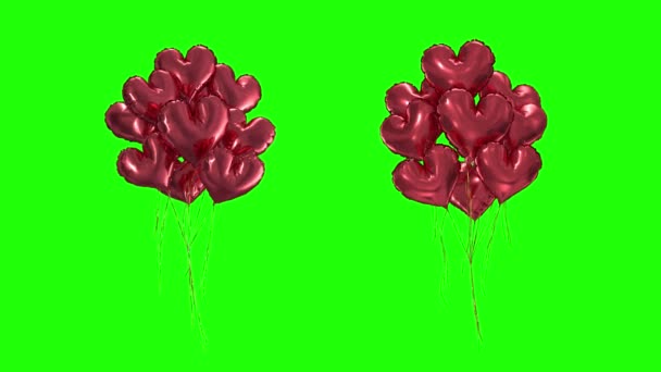 Loop Bundle de balões em forma de coração vermelho em um fundo verde — Vídeo de Stock
