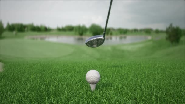 Hitting a golf ball with a club on the field front view in slow motion — Video