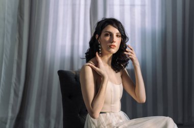 Close up studio portrait of a pretty brunettes. Looks straight into the camera.