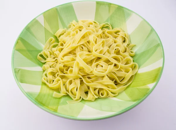 Plate with fettuccine pasta isolated on white — Stock Photo, Image