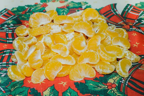 Pile of slice sections of fresh tangerine on the christmas red b — Stock Photo, Image