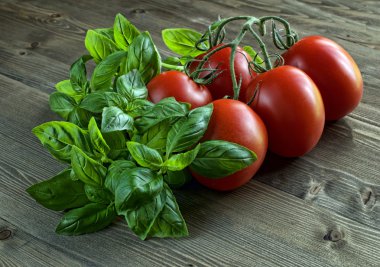 zarif domates ve fesleğen ahşap arka plan üzerinde