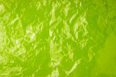 Limon rengi bir arka planda plastik poşetin dokusu. Şeffaf çanta, plastik.