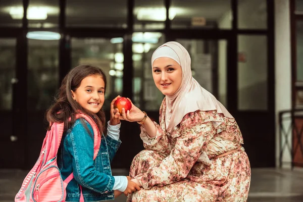 The mother prepares the girl for school. Back to school at the time of the coronavirus pandemic.New normal. Education during the Covid-19 pandemic. Selective focus.High quality photo