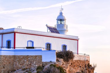 Albir lighthouse beautifully located on top of a cliff clipart