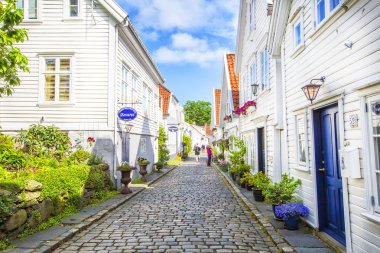 Street with white wooden houses in old centre of Stavanger. clipart