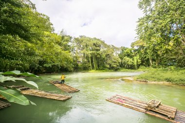 Bamboo Rafting on the Martha Brae River in Jamaica. clipart