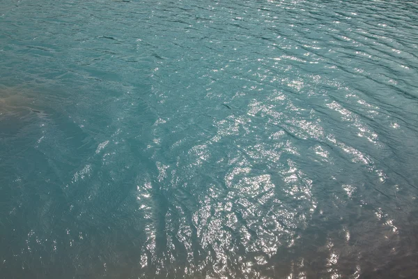 Superfície azul do mar para fundo — Fotografia de Stock