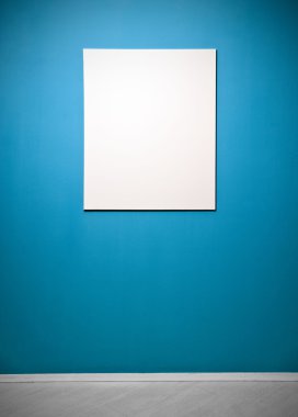 Blank picture poster in a blue gallery wall