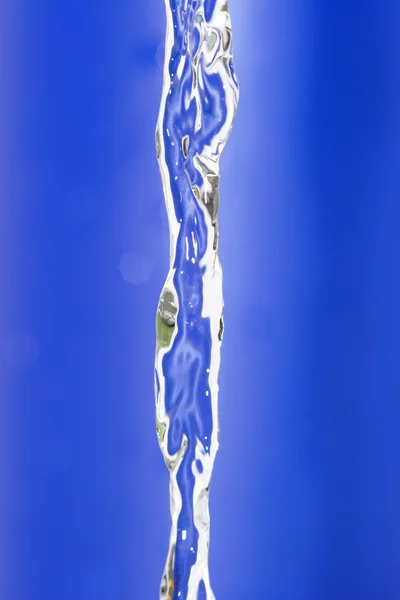 Water flow on blue background — 스톡 사진