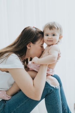 Güzel anne portre sevimli küçük kızı bir beyaz odada ile sabah oynarken