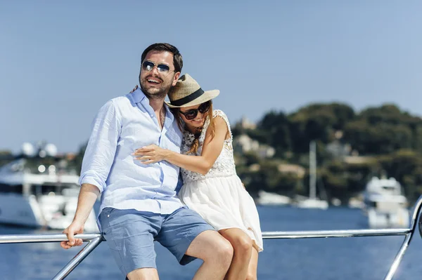 Atractiva pareja en un yate disfrutar de un día soleado brillante de vacaciones — Foto de Stock