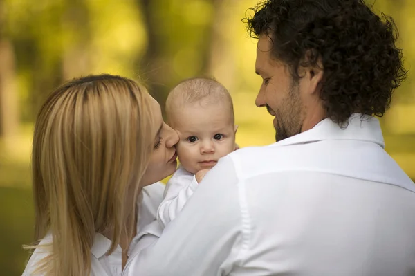 Happy parents having good time with their little boy in green park — Stock Photo, Image