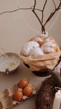 Pasta yumurtaları ve yanan mumlarla süslü bir çelenk ile Paskalya masası yavaşça kameraya yaklaşıyor ve neşeli bir ortam yaratıyor. Yüksek kalite 4k görüntü