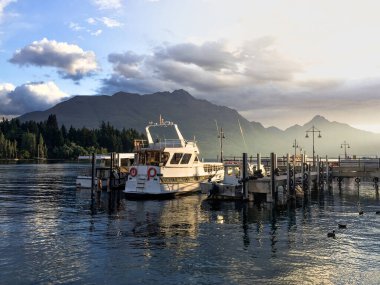 Wakatipu Gölü 'nde güzel bir altın gün batımı. Queenstown 'da turist gezisi. Güney Yeni Zelanda 'ya seyahat et..