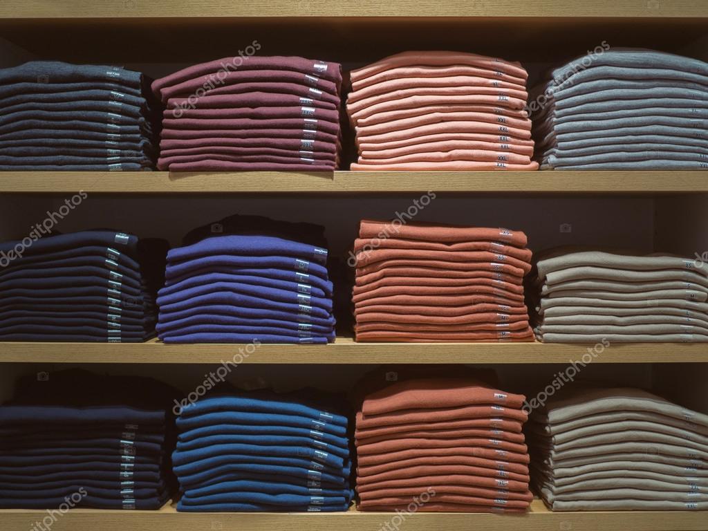 Shelving fashion. Neatly folded clothes. Shelf with a new collec Stock Photo segastock gmail 123287478