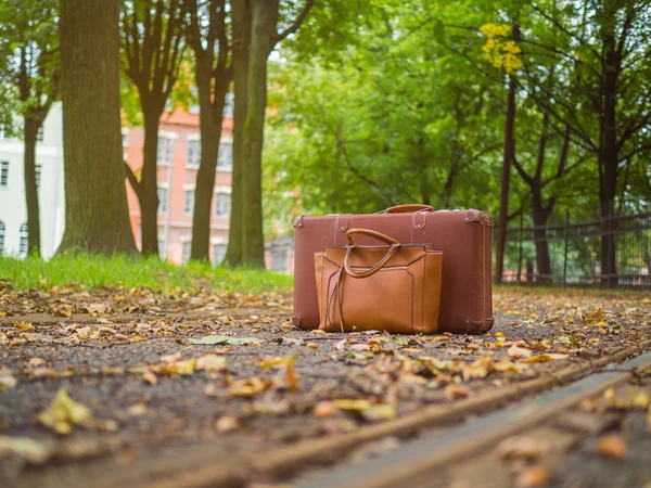 Baggage is near the railroad. Waiting for transport.