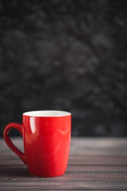 Kırmızı Kupası ve karanlık bir arka plan üzerinde siyah kitaplar
