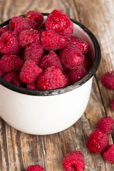 Raspberries in a bowl on a table — Stock Photo, Image