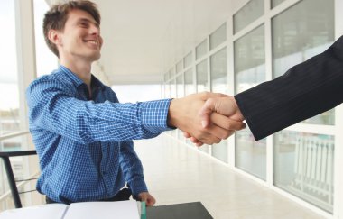 Close-up image of a handshake standing for a trusted partnership . Woman and man shake hands. Partnership, trust, good deal.