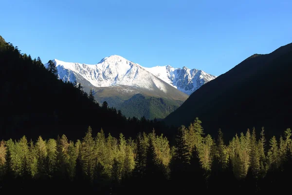 Hermoso paisaje de montaña en la puesta del sol. Montaña nevada y soleada — Foto de Stock