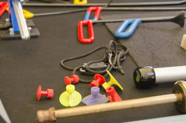 Paintless Dent Repair Kit Tools Set On The Work Table. Tools For Repair Dents On Car Body. Glue tabs With Slide Hammer.