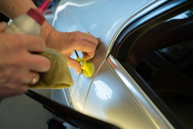 Process Of Paintless Dent Repair On Car Body. Technician s Hands With Puller Fixing Dent On Rear Car Fender. PDR Removal Course Training