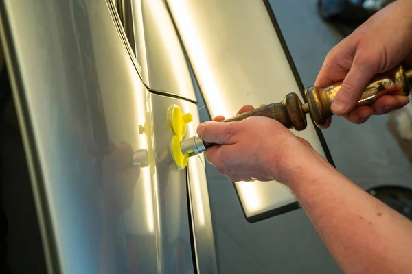 Process Of Paintless Dent Repair On Car Body. Technician s Hands With Puller Fixing Dent On Rear Car Fender. PDR Removal Course Training — Stock Photo, Image