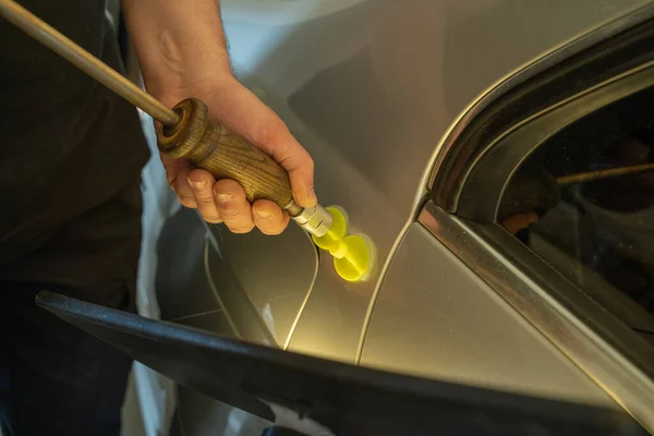Process Of Paintless Dent Repair On Car Body. Technician s Hands With Puller Fixing Dent On Rear Car Fender. PDR Removal Course Training — Stockfoto
