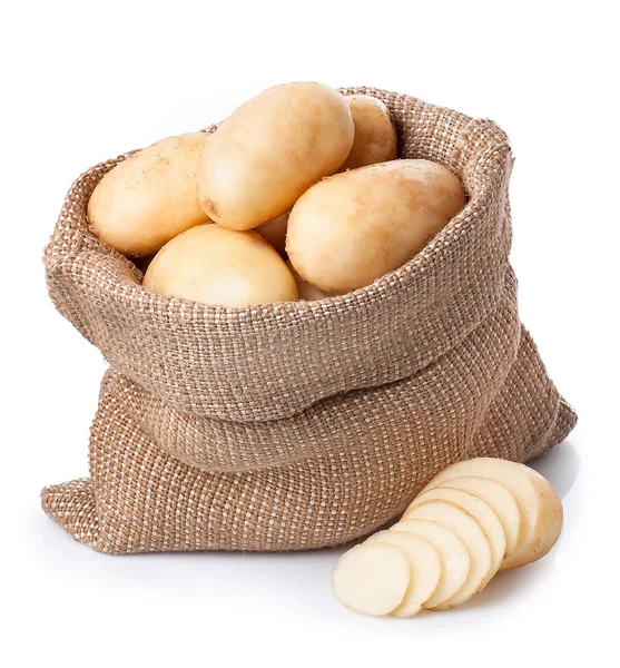 Potatoes in burlap bag with sliced potato beside isolated on whi — Stock Photo, Image