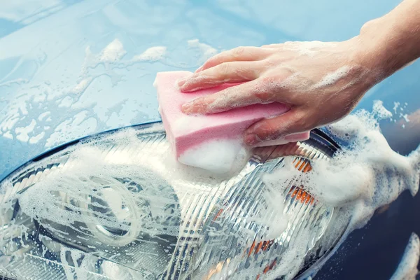 closeup from a car cleaner with a sponge and foam