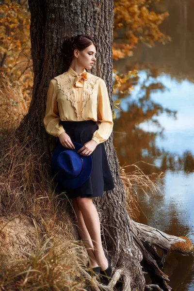 Woman dreaming near the river in autumn season — Stock Photo, Image