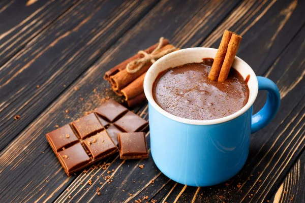 Cup of hot chocolate with cinnamon stick — Stock Photo, Image