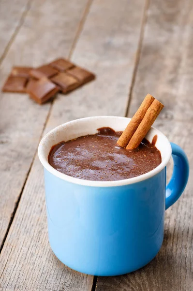 Cup of hot chocolate with cinnamon stick — Stock Photo, Image