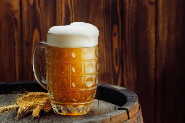 Mug of beer on barrel — Stock Photo, Image