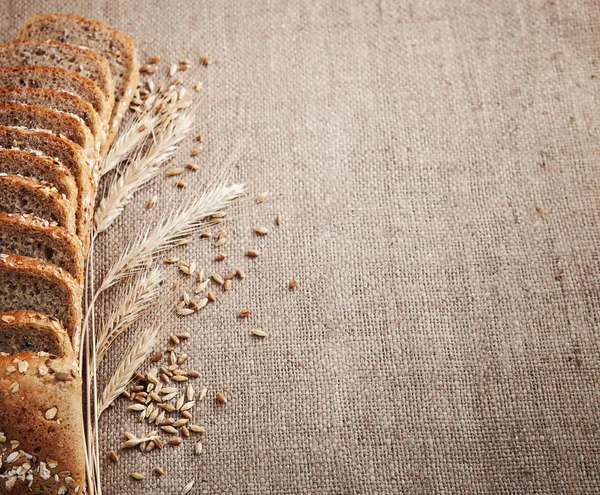 slices of bread and ears of corn on sackcloth