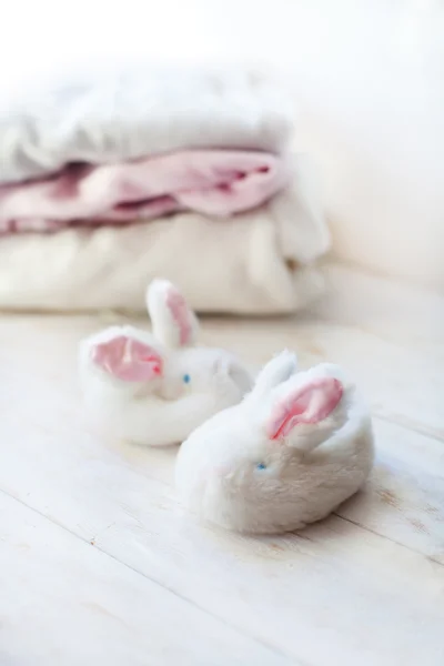 children's shoes. Slippers with bunnies on the background of clothing