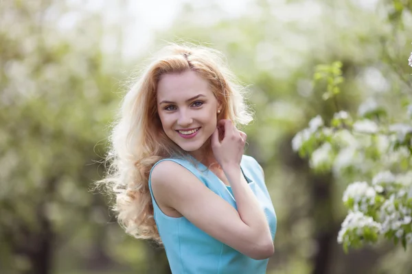 Beautiful young blonde woman in spring 