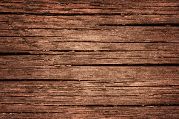 Yaşlanmış ahşap kaplama. Koyu kahverengi bir masa ya da çatlak duvarın pürüzlü ve detaylı yüzeyi..