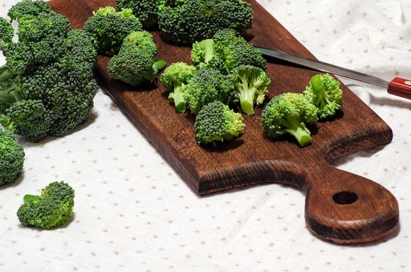 Fleurs de brocoli sur une planche de cuisine et couteau — Photo