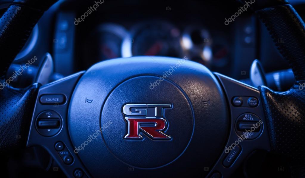 SISTIANA, ITALY JUNE 12, 2013: Photo of  Logo Nissan GT-R Black Edition. The Nissan GT-R is a 2-door 2+2 sports car produced by Nissan and unveiled in 2007. BLUE TONING.