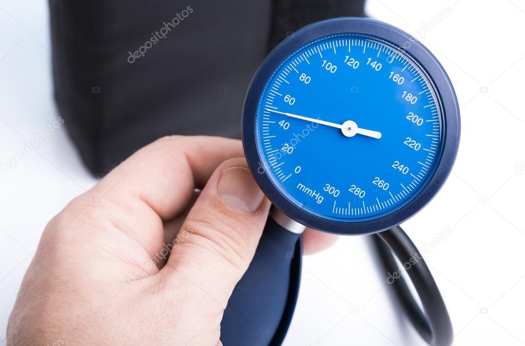 Holding in hand sphygmomanometer isolated on white background